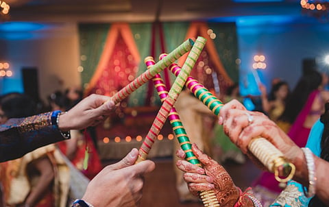 People enjoying dandiya at an event