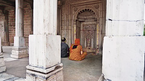 Devotees praying in front of the 'mihrab' (chamber indicating Mecca's direction)