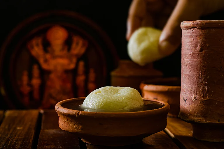 Bengali sweets of festival, Rasgulla, is served in an earthen placed filled with the sugar syrup on the occasion of Bengali festival, Durga Puja - Shutterstock