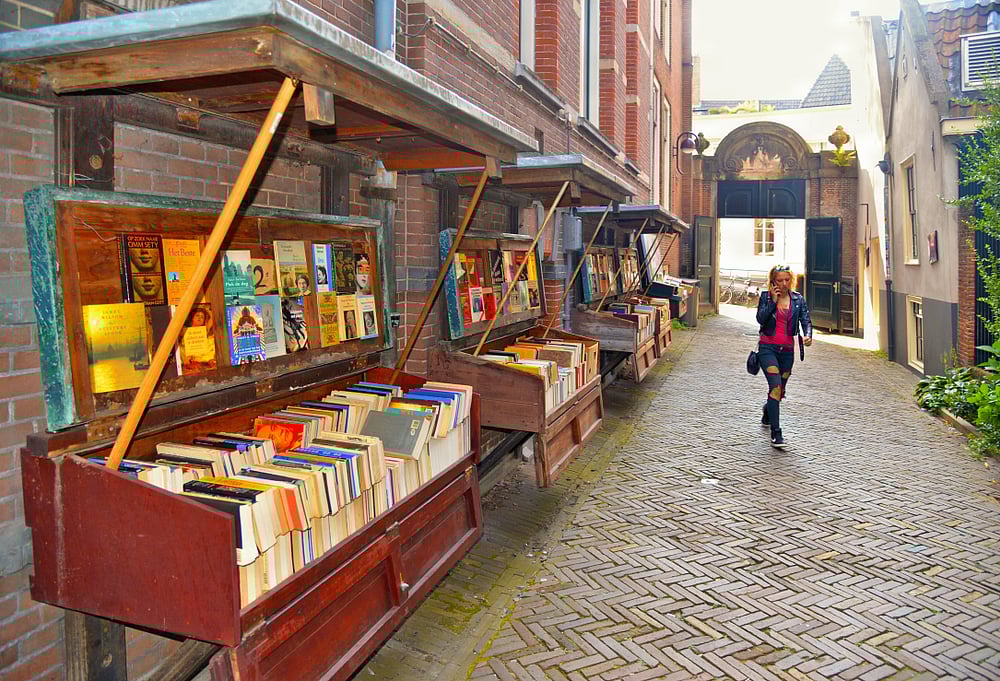 Oudezijds Achter Burgwal street end book stall market in historical centre of Amsterdam, Netherlands