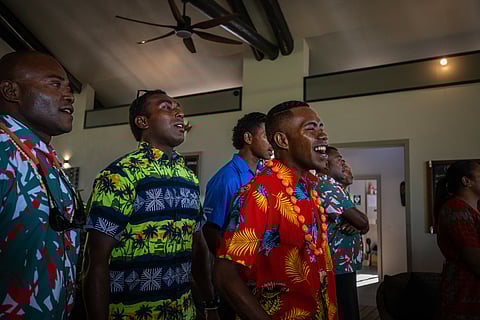 Men sing while wearing Bula shirts in Fiji