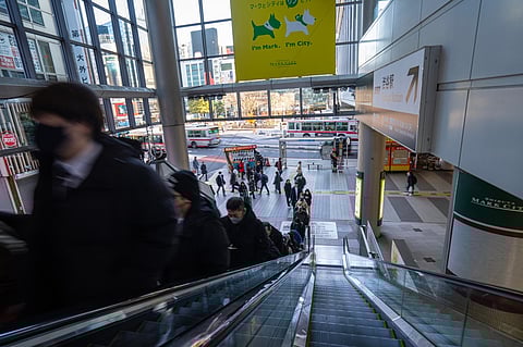 People going up an escalator in a shopping center in Tokyo