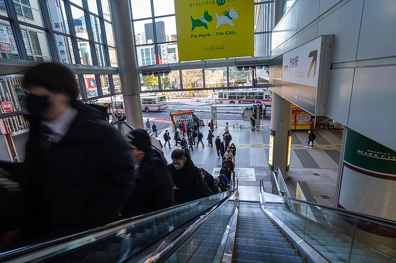 People going up an escalator in a shopping center in Tokyo