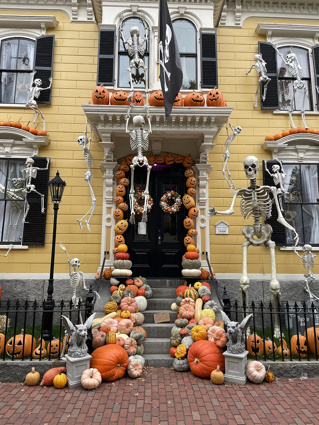 A historic home in Salem, Massachusetts is decorated with skeletons and pumpkins for halloween