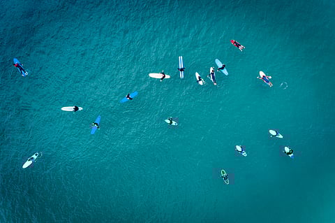 Surfers off the shore of Baleal Beach