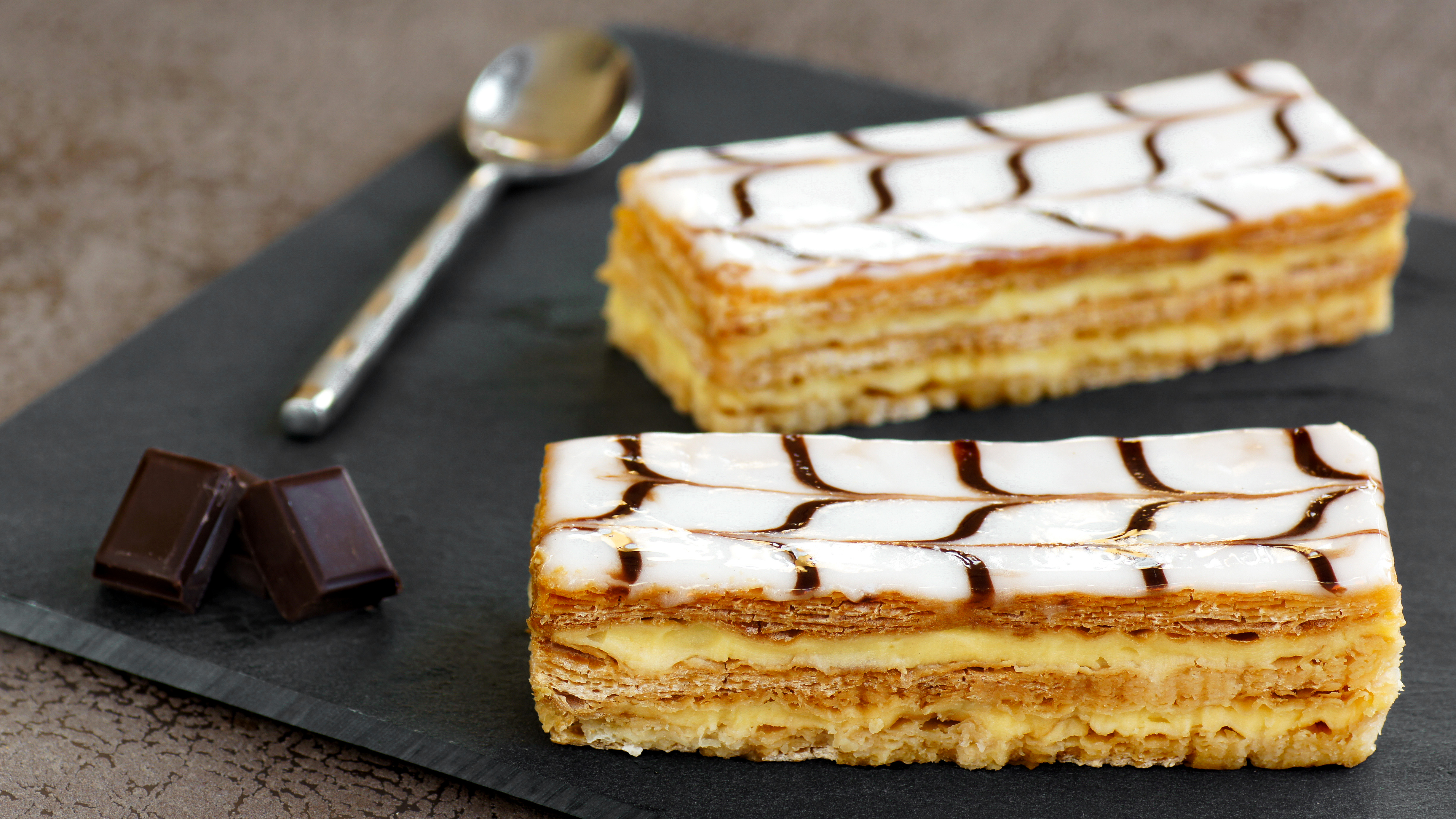 Mille-feuilles are filled with vanilla pastry cream; variations may include chocolate, coffee, or fruit flavouring