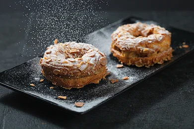 Enya/Shutterstock : The Paris-Brest is usually served in a ring shape and can be cut into individual portions