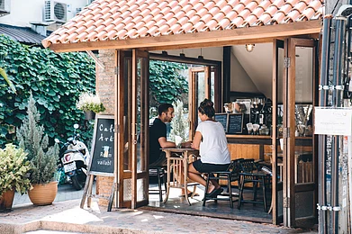 Shutterstock : A couple sitting in a cosy coffee shop at Chiang Mai.