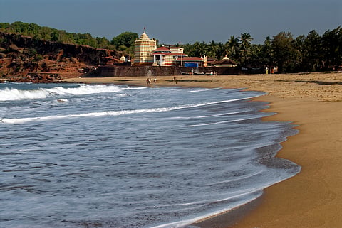 Waves on the beach near the temple's edge
