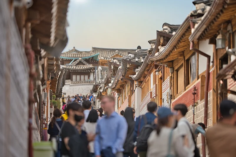Tourists in front of traditional houses in Bukchon Hanok Village, Seoul