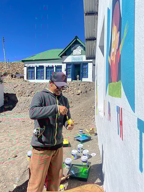 Nawang Tankhe paints a mural for Hikkim's local govt. school