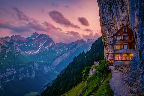 Swiss Alps and a mountain restaurant under the Aescher cliff 