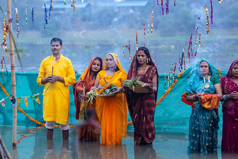 Devoties offer prayers and arghya (offerings) to the setting sun