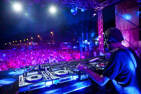 A DJ plays live music to an audience