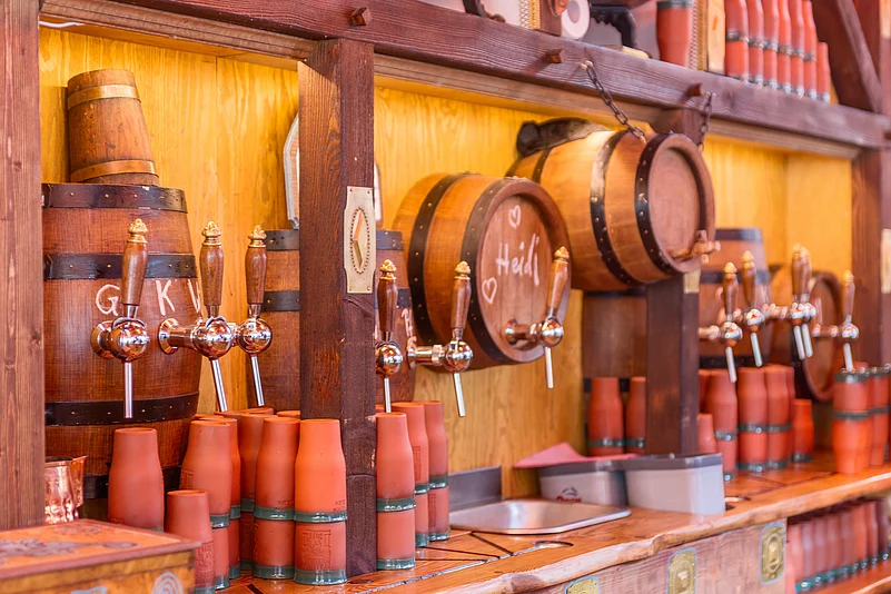A steaming mug of glühwein (mulled wine) served in specially decorated mugs is a must during your tour of the Striezelmarkt