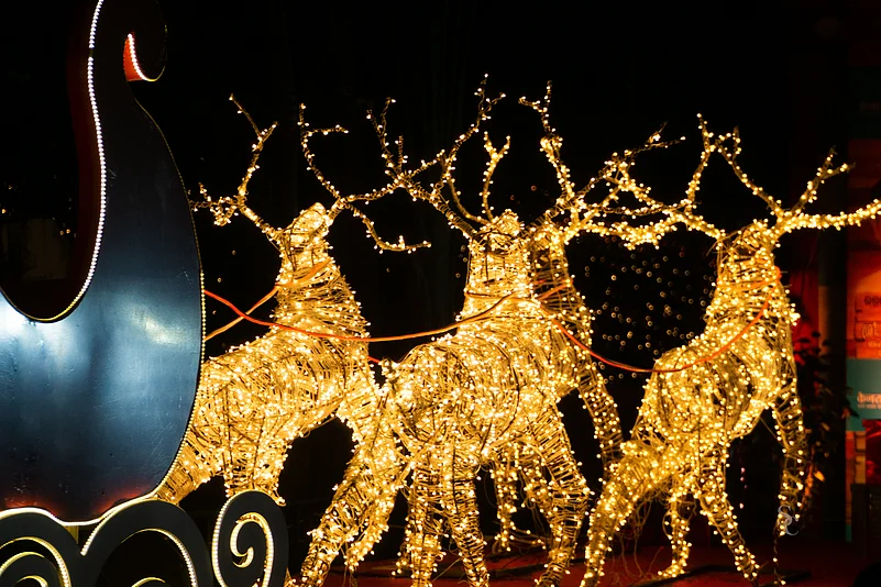 Reindeer made of decorative lights pulling a chariot for sale in a Thiruvananthapuram market