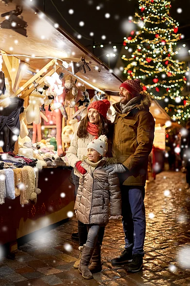 Shutterstock : A family enjoys their time at a Christmas town