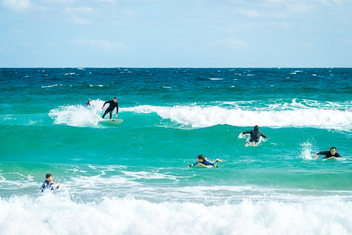 Surfers in the waters off Bondi Beach