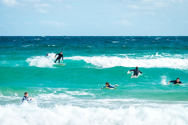 Surfers in the waters off Bondi Beach