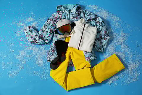 A winter clothing jacket and trousers, a couple of inner thermal layers, warm socks, sunglasses, sunscreen, and warm waterproof gloves are essential to pack for a skiing trip