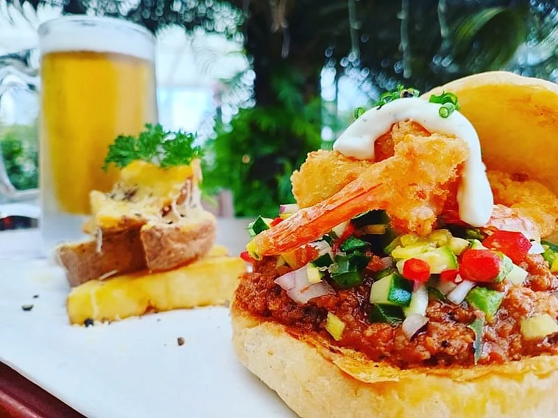 Special: Surf N Turf Burger (ground beef and shrimp salsa) served with cheesy wedges and a chilled draft