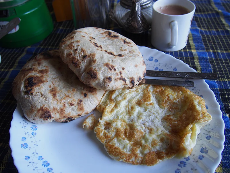 Khambir is a thick and round whole wheat bread that is often paired with butter tea