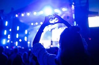 Shutterstock : A woman at a concert (representational image)