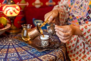 Shutterstock : Pouring Turkish coffee from cezve into cup