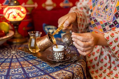 Shutterstock : Pouring Turkish coffee from cezve into cup