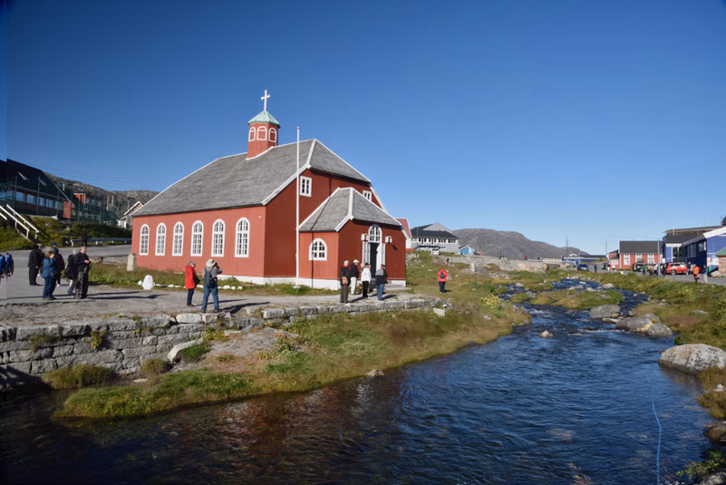 Visitors at the Church Of Our Savior Lutheran Church built in 1832 in Qaqortoq
