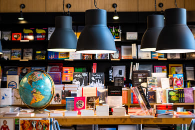 Shutterstock : Inside a bookshop with black metal electric lamps hanging