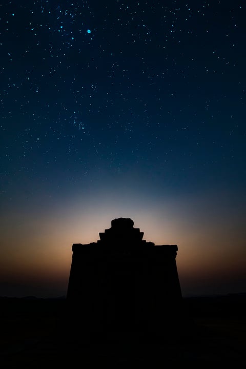 A temple silhouetted against the night sky