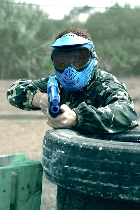 Paintball involves the use of low-energy air weapons to hit people with spherical dye-filled gelatin capsules