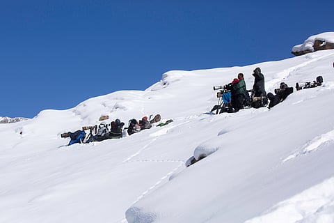 A group of photographers in Kibber wait to capture a glimpse of the snow leopard