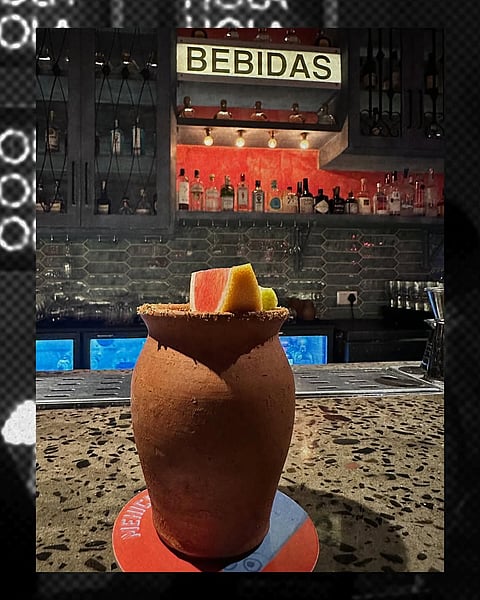 Cantarito, a traditional Mexican cocktail, is served in a clay cup