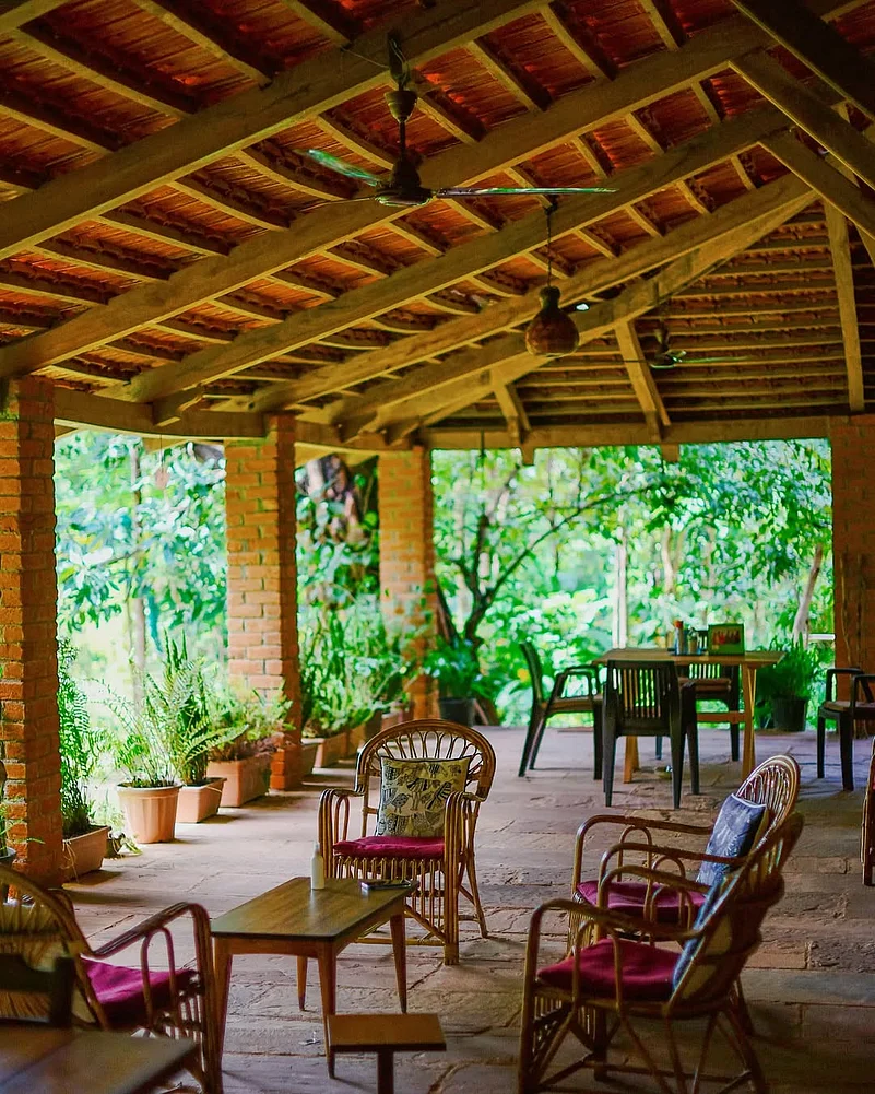 The bungalow features a red-tiled roof and a beautiful veranda