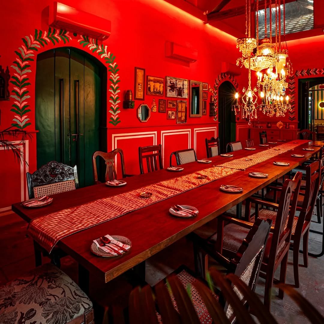 The ambience reflects the heritage of Tamil Nadu with intricate wooden furnishings, traditional brass lamps, and vibrant murals