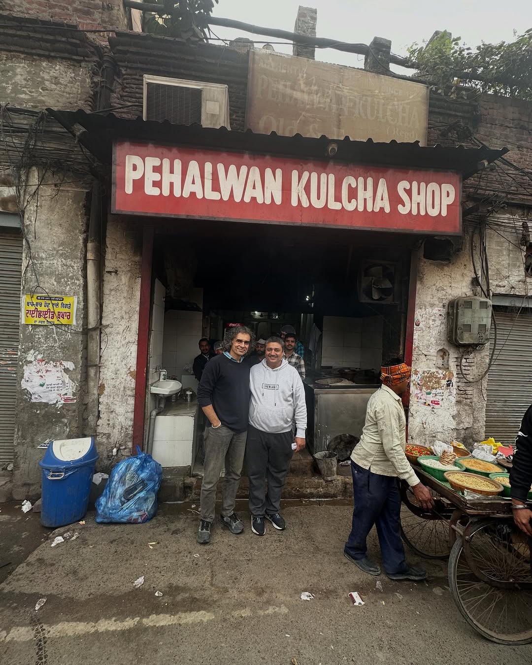 Imtiaz Ali poses with the owner at Pehalwan Kulcha Shop