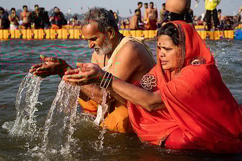 Hindu worshippers pray and bathe at the Kumbh Mela in Prayagraj