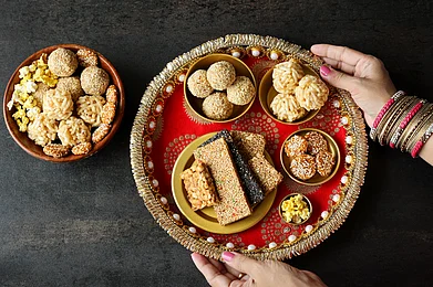 Santhosh Varghese/Shutterstock : A platter of snacks that are made during Lohri celebrations