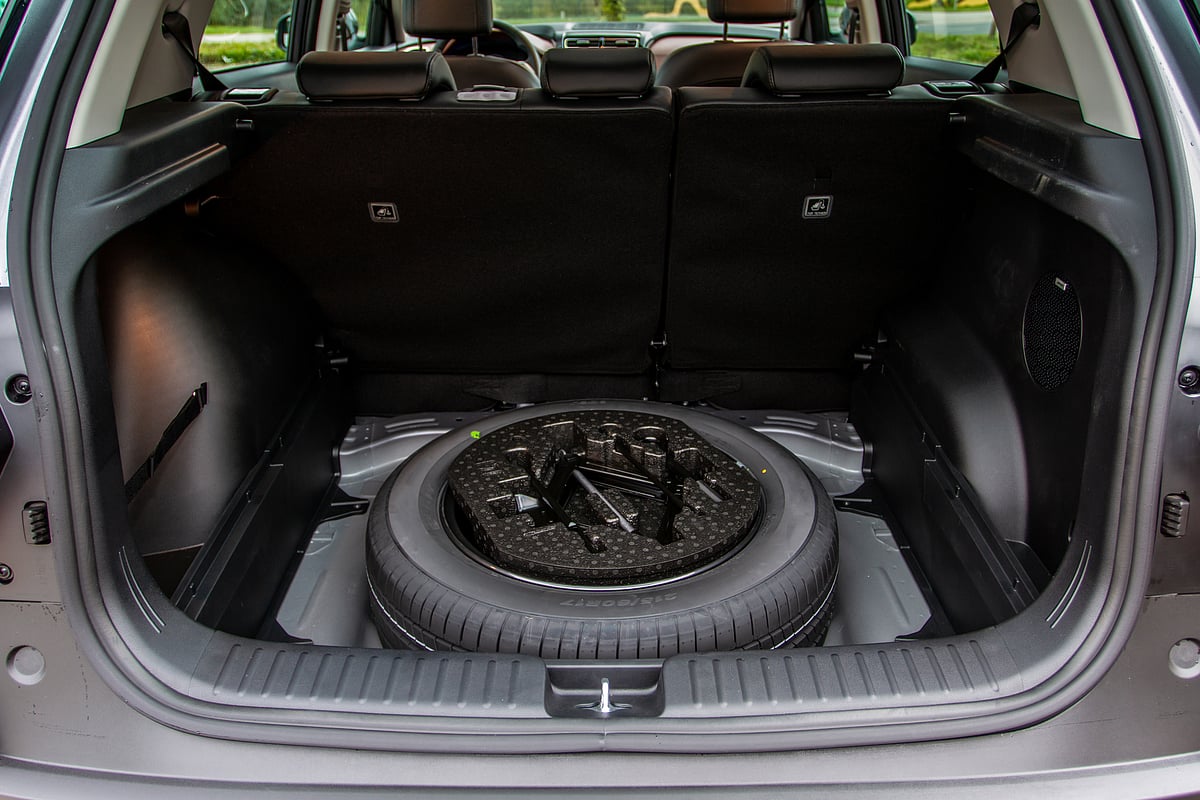 A spare wheel in the trunk of a car
