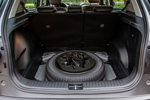 A spare wheel in the trunk of a car