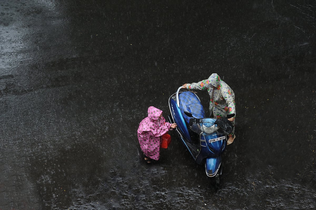 People wearing raincoats in Mumbai
