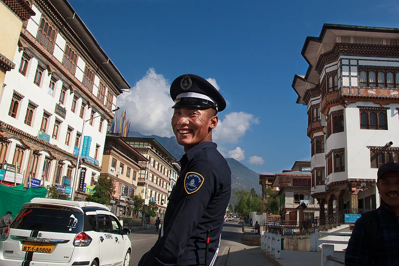 In the streets of Thimphu, a Bhutanese police officer controls traffic with a calm yet authoritative presence