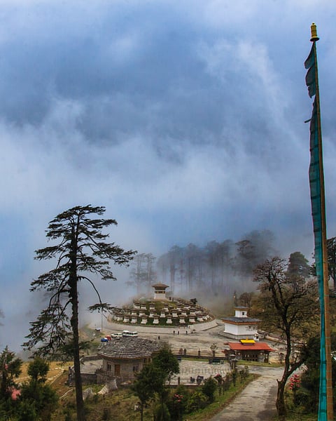 Dochula Pass felt like a scene from a dream. The 108 chortens, as a memorial to the Bhutanese soldiers who died in the 2003 war, stood quietly, their white walls fading into the mist that rolled in suddenly