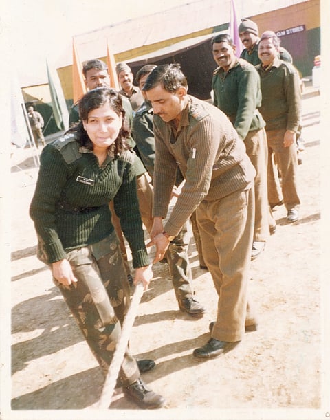 A fun moment with her colleagues playing tug of war