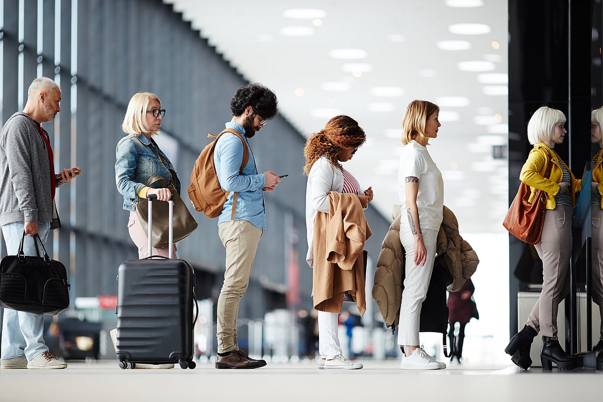 Shutterstock : Passengers queue for boarding a flight
