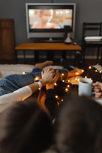 Shutterstock : A couple watching television together