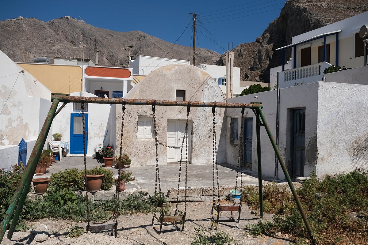 Empty swings in a playground on Santorini