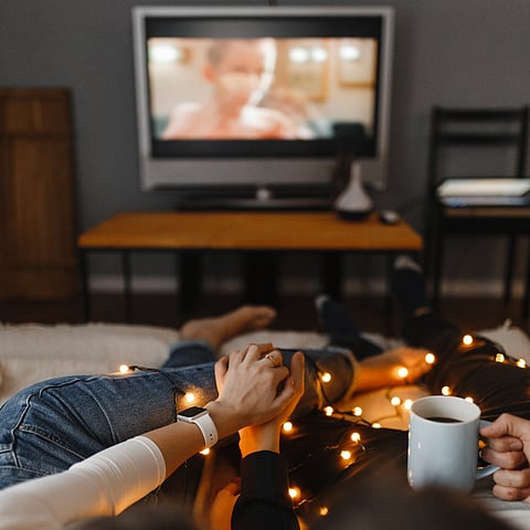 A couple watching television together